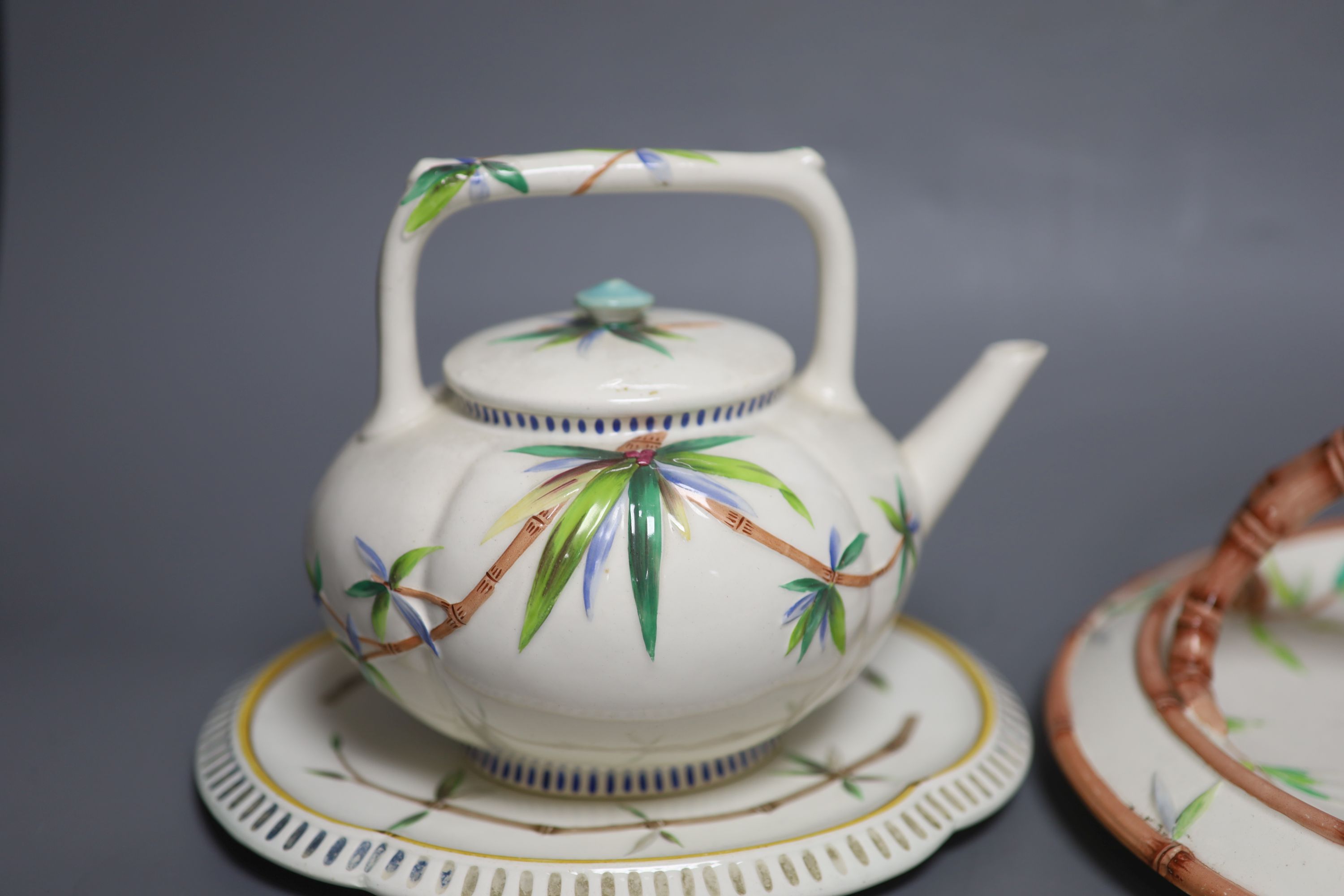 A Wedgwood Aesthetic period bamboo sprig teapot and stand and a basket